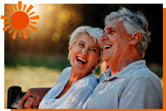 Older couple laughing and enjoying reduced energy costs thanks to Osmo Solar-Fence